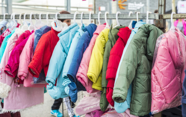 Badalona, Spain - November 1, 2014: Stall clothes in the market Turo Caritg in Badalona, a town next to Barcelona. The vendors serve customers while they choose and seek something you like